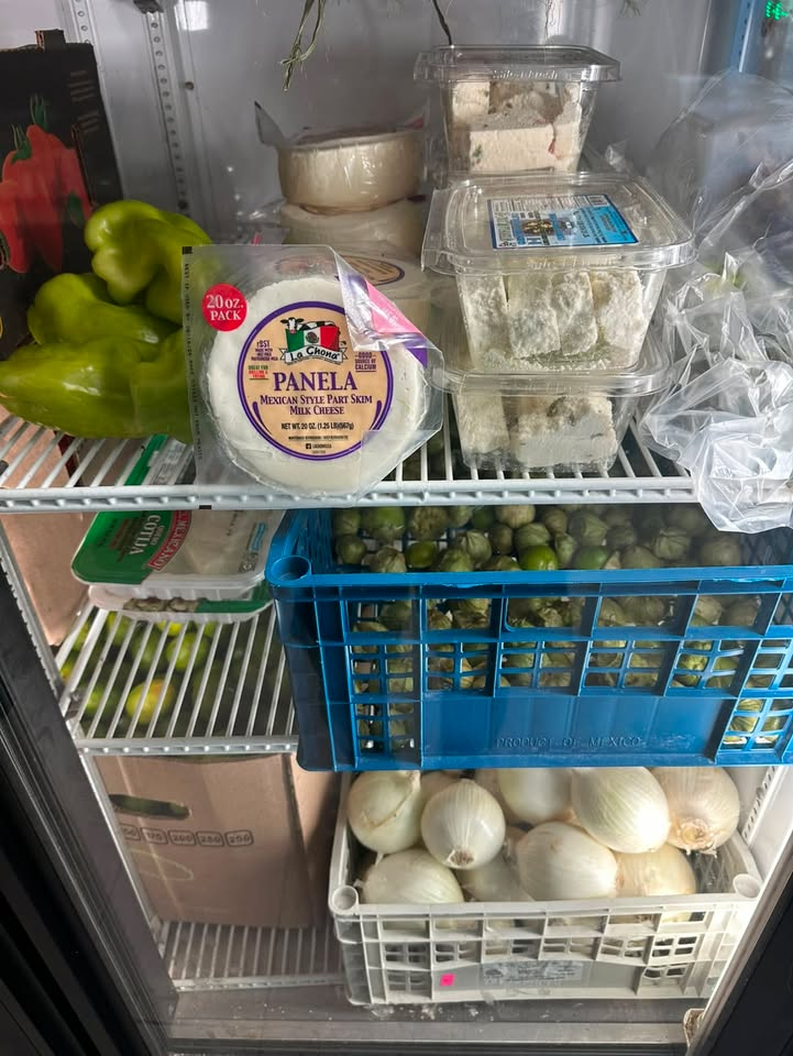 Refrigerated case with fresh cheese, tomatillos and onions