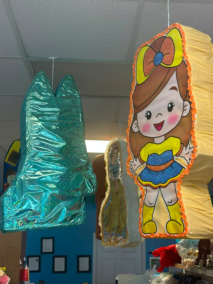 Colorful piñatas hanging in store